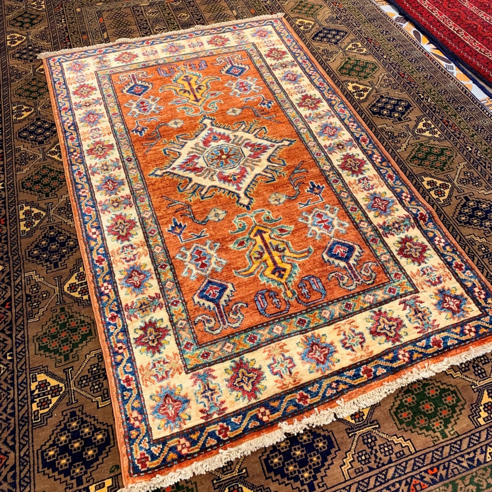Decorative rug with intricate patterns on a carpeted floor